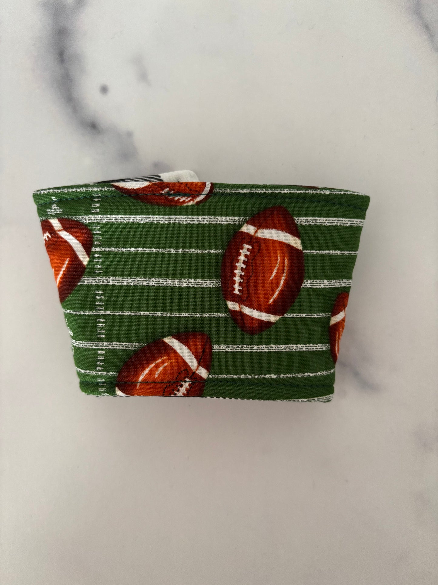 Footballs on Green - Reusable Coffee Sleeve