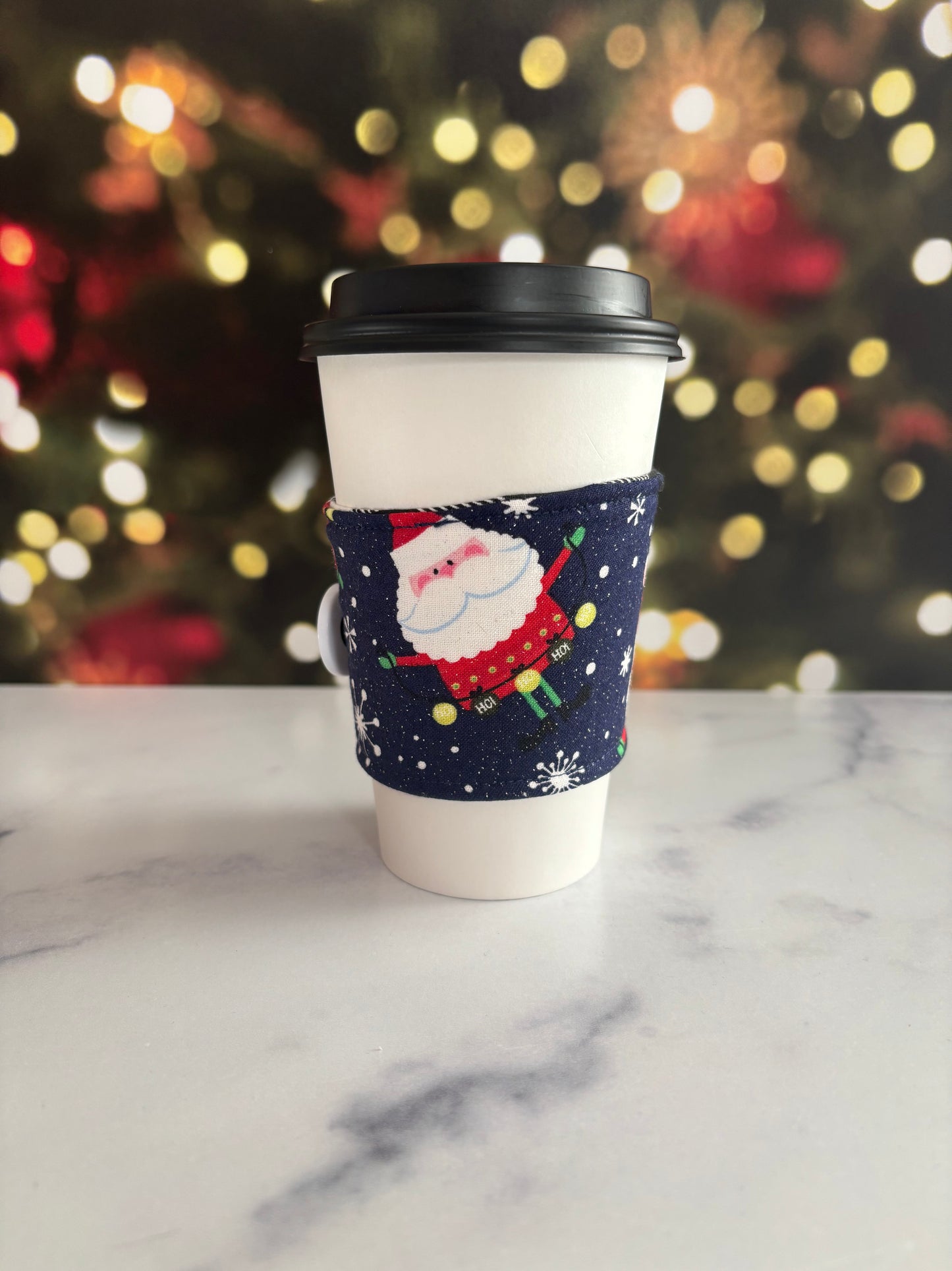 Sparkly Santas on Blue - Reusable Coffee Sleeve