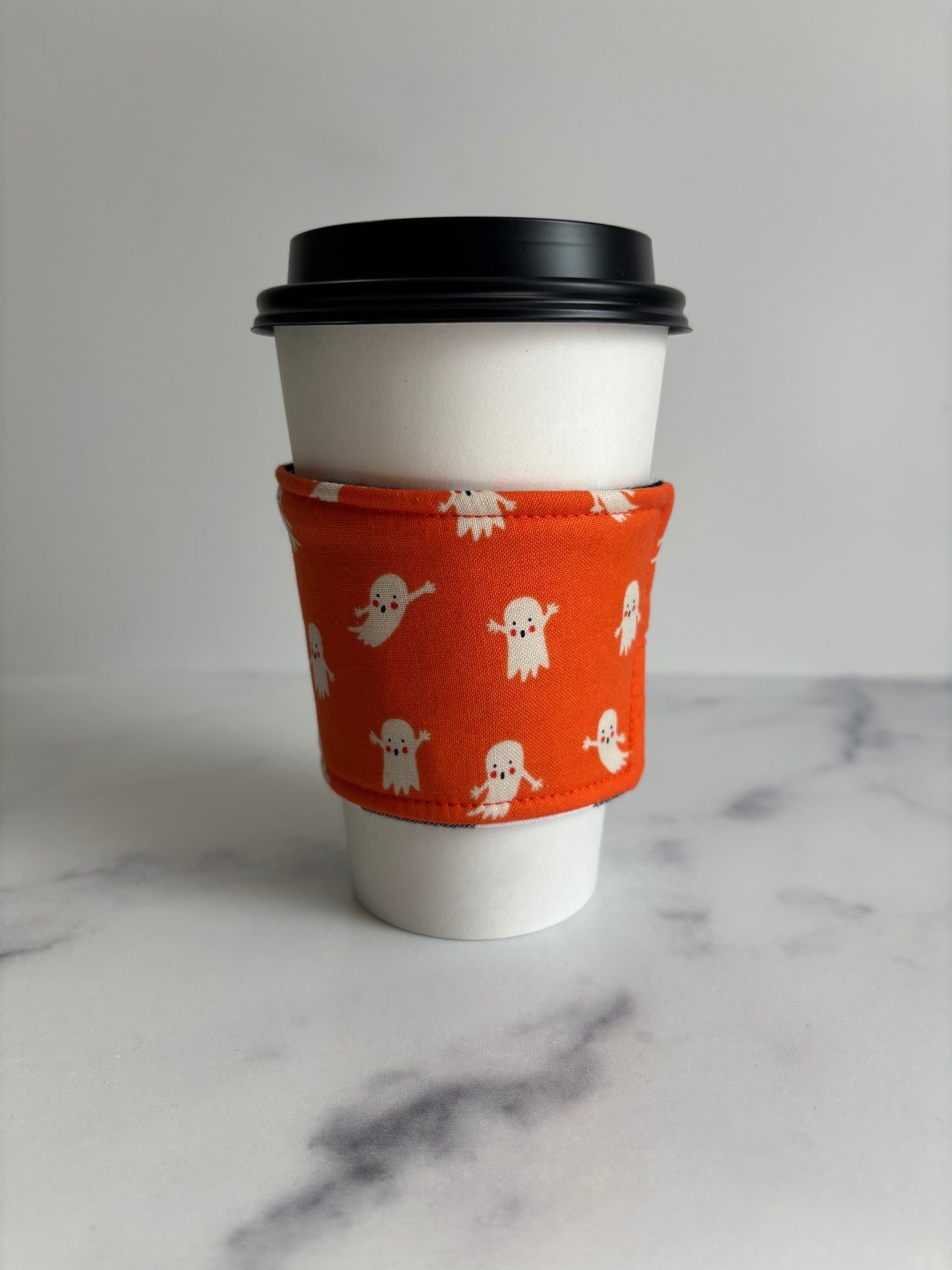 Ghosts on Orange - Reusable Coffee Sleeve